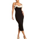Black dress with floral straps on a white background