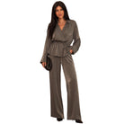 A woman modeling a two-piece satin jumpsuit in a muted taupe-brown color, featuring a wrap-style long-sleeve top with a tie waist and matching wide-leg pants, set against a plain white background.