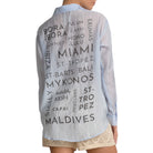 Light blue shirt with text print worn by a person on a white background