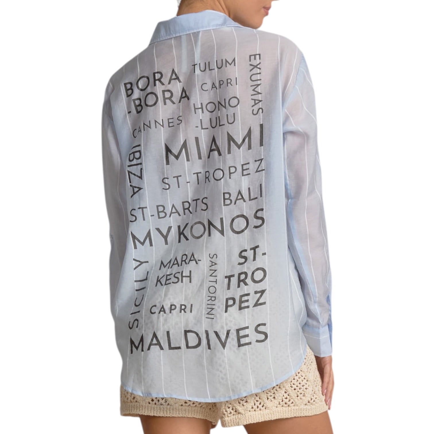 Light blue shirt with text print worn by a person on a white background