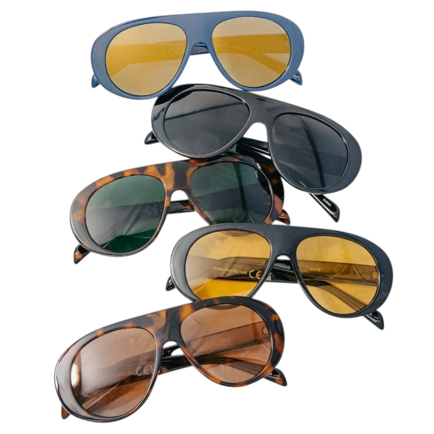 Stack of sunglasses with different designs and colors on a white background