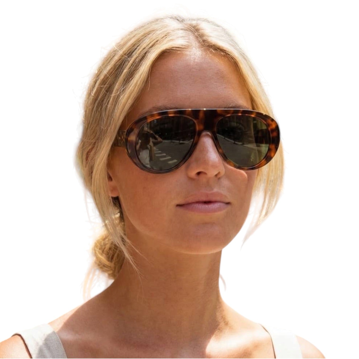 Woman wearing tortoiseshell sunglasses with a plain background