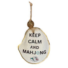 An irregular-shaped white ornament with a gold-colored edge, featuring the text 'KEEP CALM AND MAHJONG' in black, with a small mahjong tile illustration at the bottom and a hanging loop at the top.