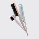 Set of hairbrushes and combs on a light gray background