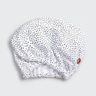 White hair towel with black polka dots on a light gray background