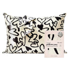 Satin pillowcase with black heart pattern and packaging on a white background