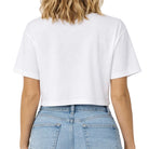 Person wearing a white t-shirt and blue jeans on a plain background