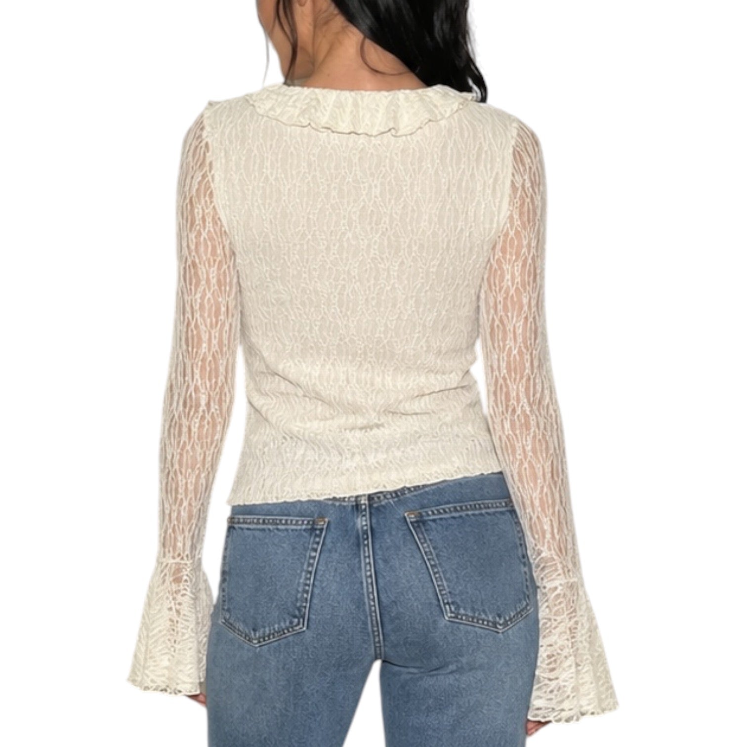 A woman shown from the back wearing a cream-colored textured knit top with sheer lace long sleeves and a ruffled neckline, paired with blue jeans against a plain white background.