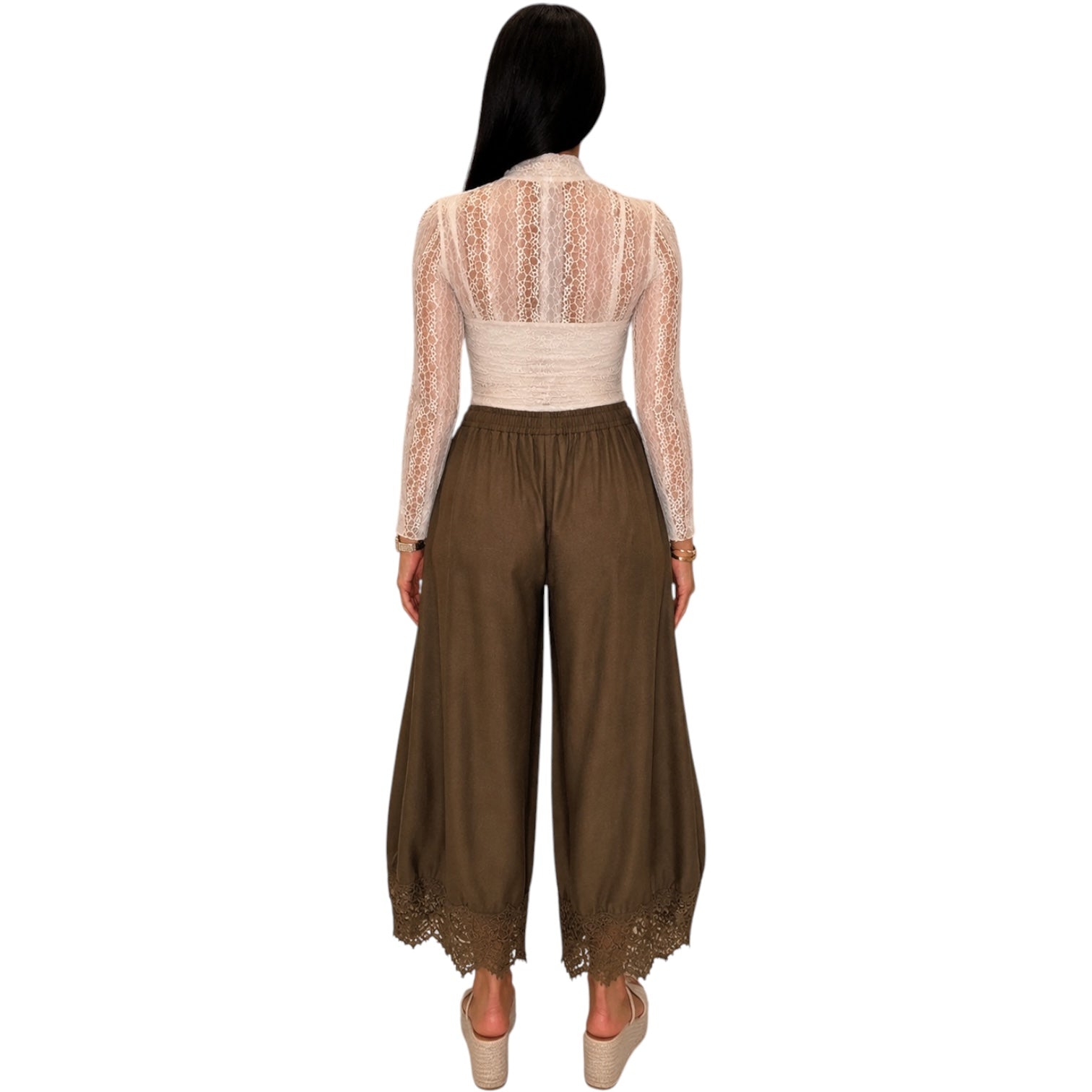 A woman shown from the back wearing a beige lace long-sleeve crop top and brown wide-leg pants with lace trim at the hems, against a plain white background.