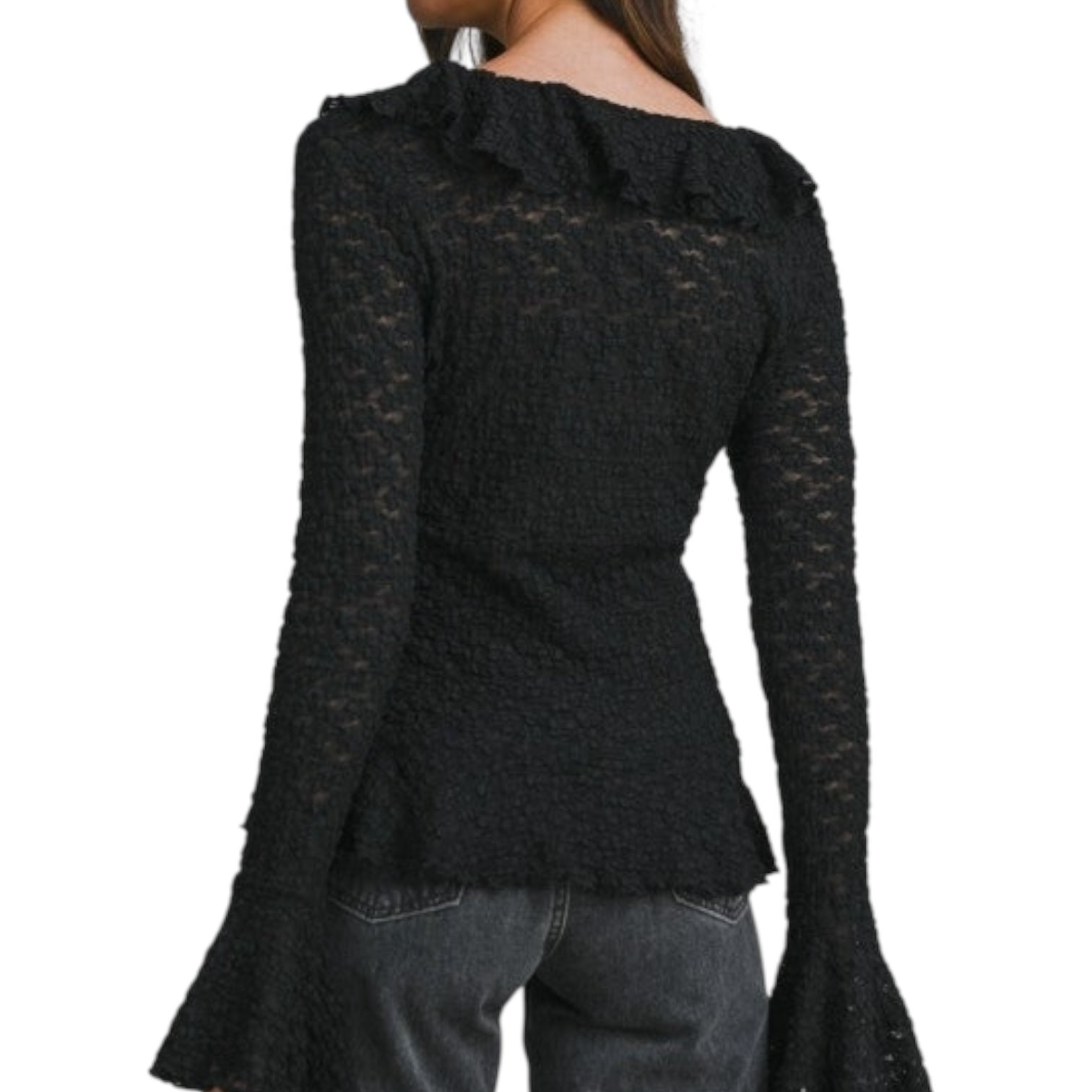 Black textured long-sleeve top worn by a person on a white background