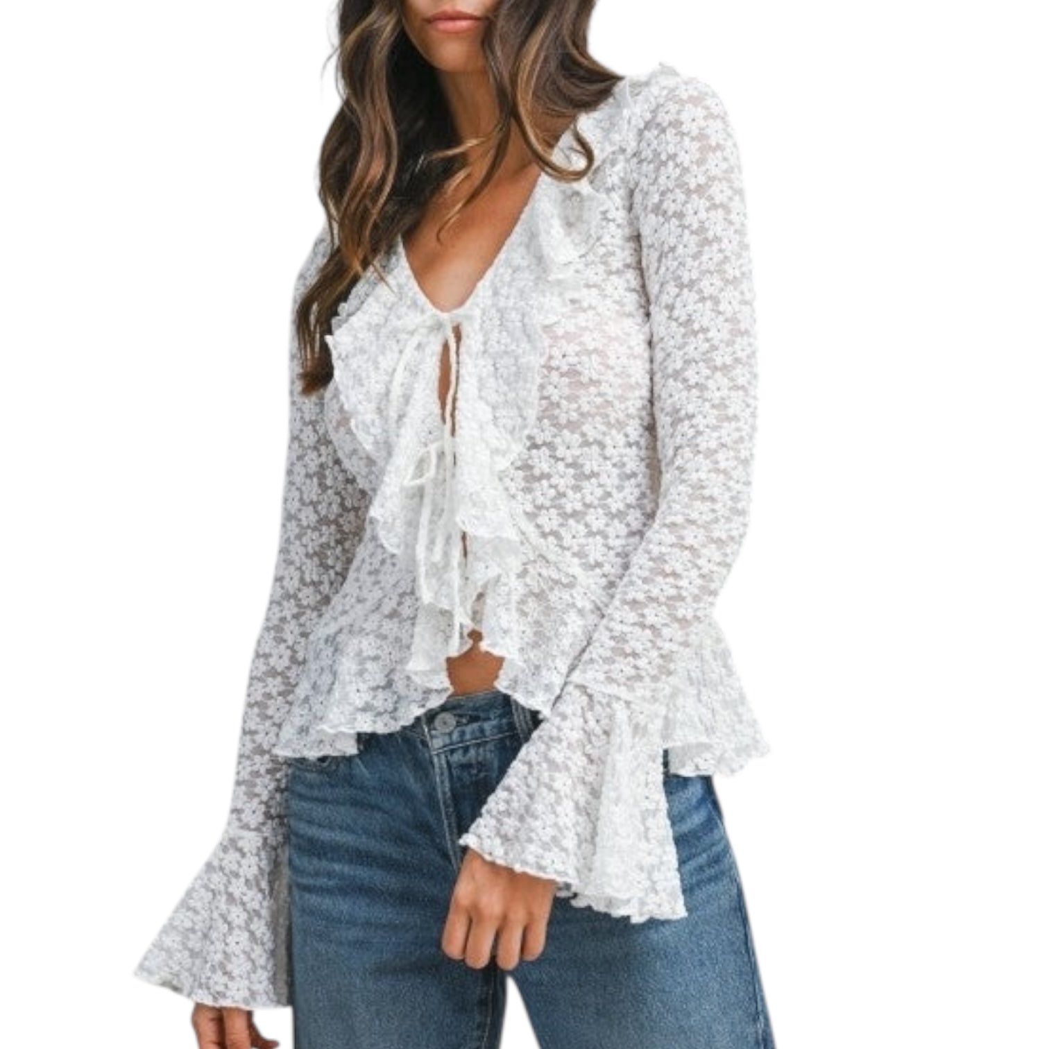 Woman wearing a white lace blouse with long sleeves and blue jeans on a white background