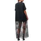 Black oversized top with sheer black lace overlay on a white background