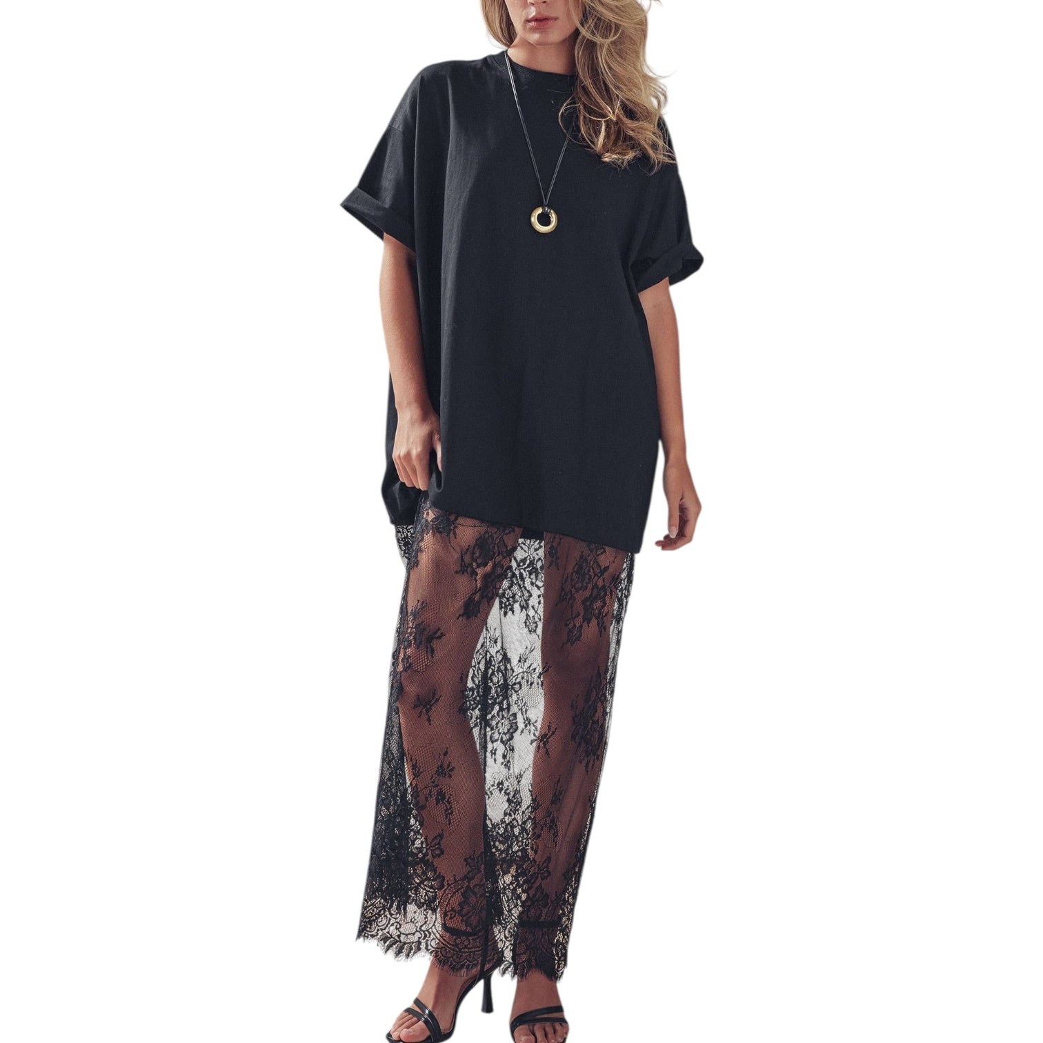 Woman wearing a black top and lace skirt on a white background