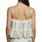 Woman wearing a floral lace top with thin straps on a white background