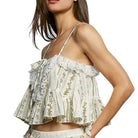 Woman wearing a floral lace top on a white background