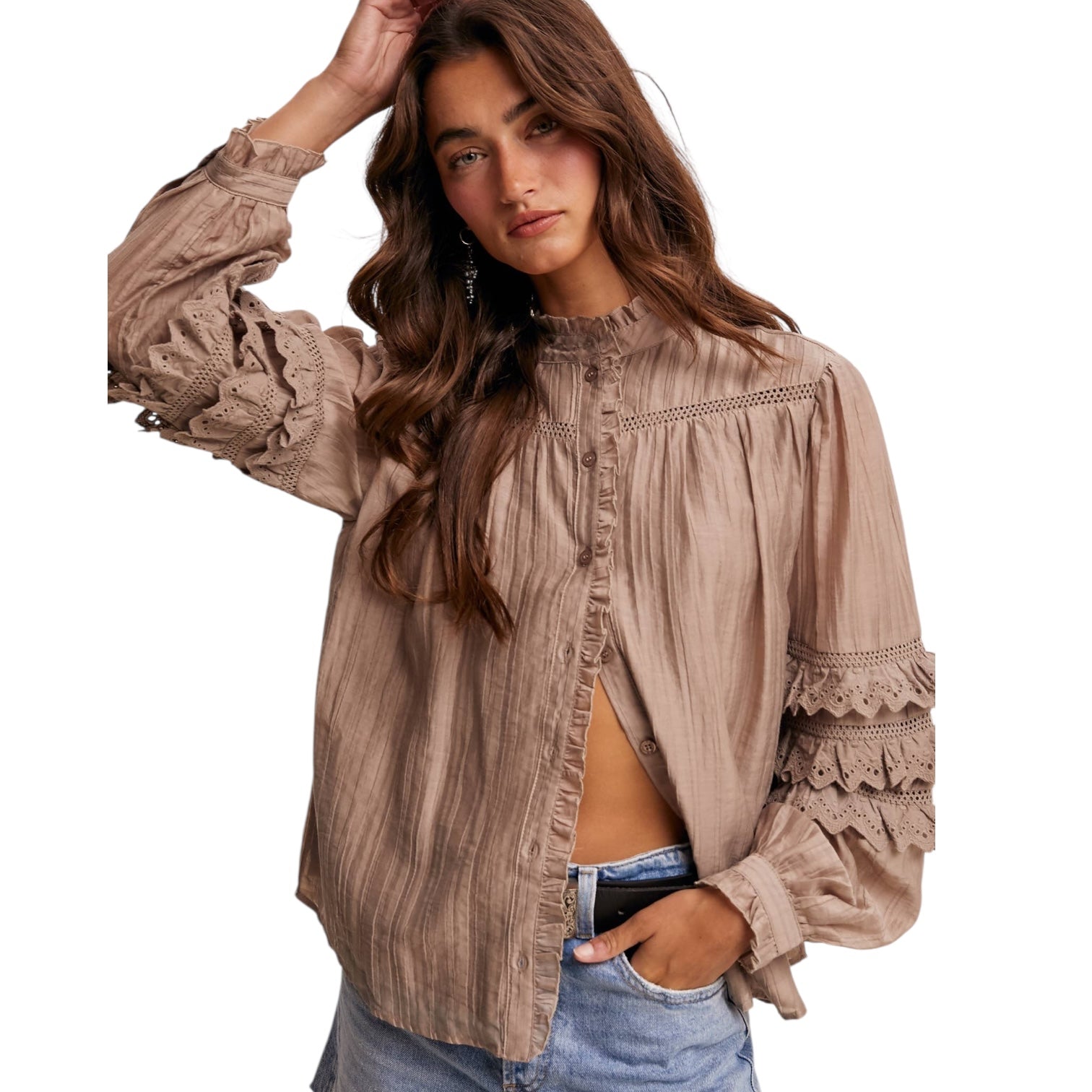 Woman wearing a beige lace-trimmed blouse on a white background