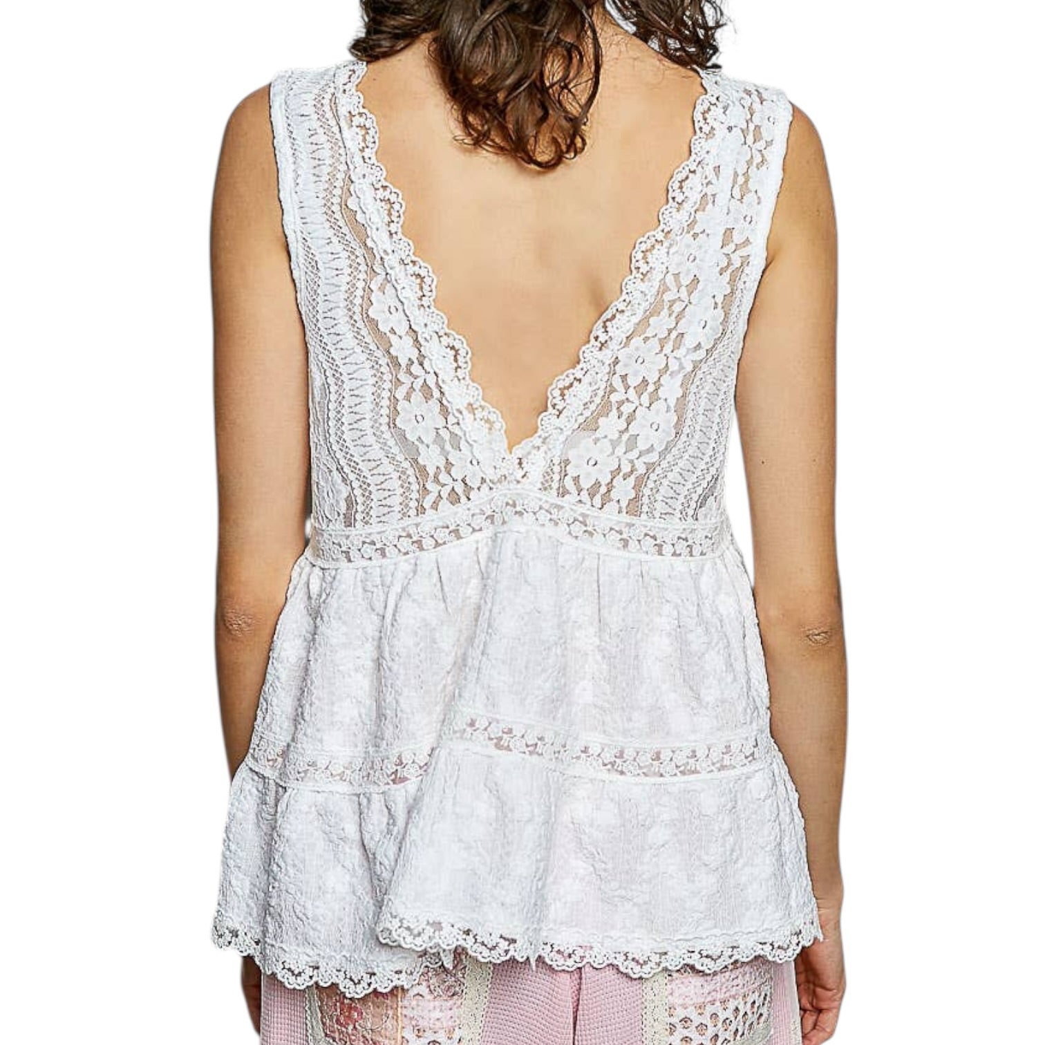 White lace top worn by a person on a white background