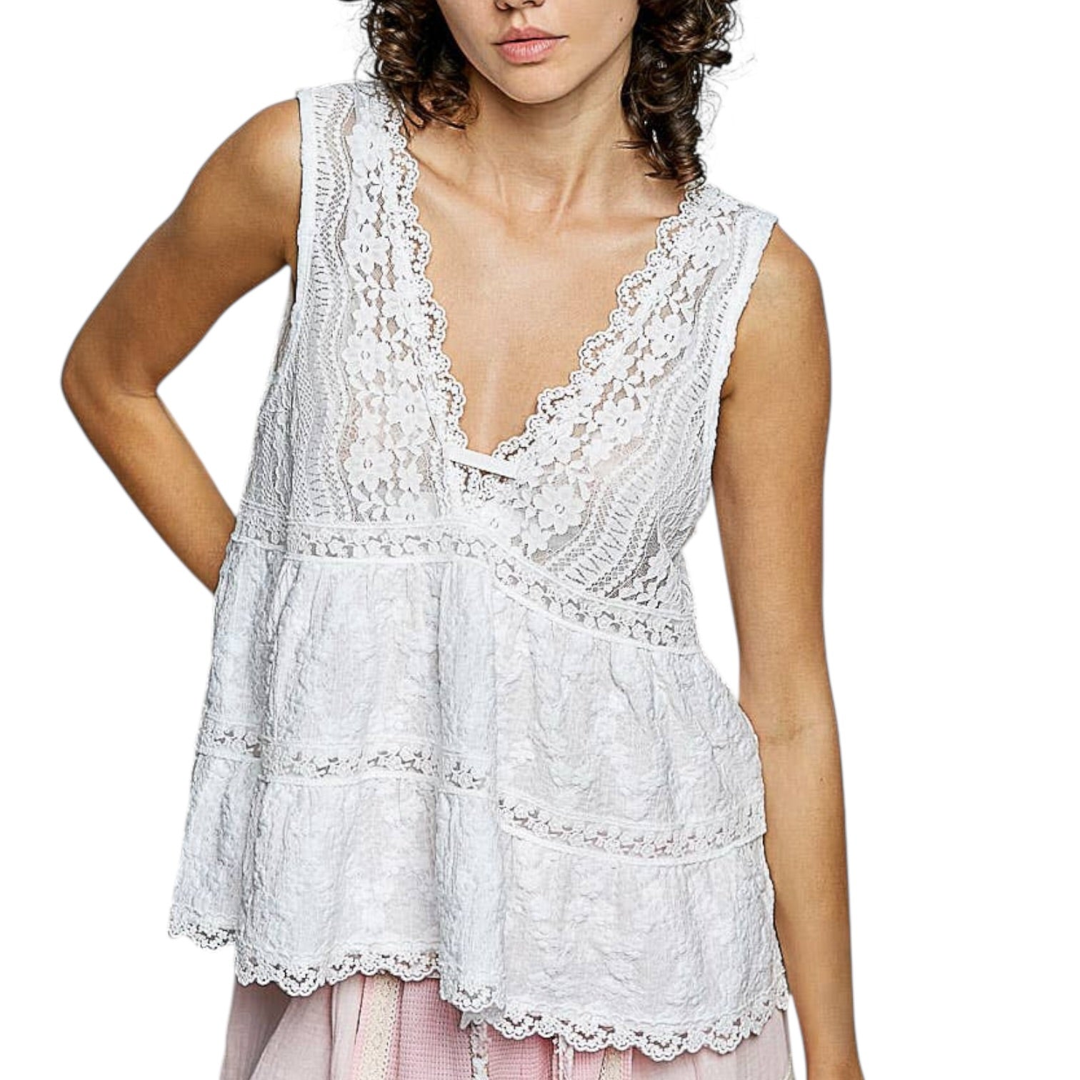 Woman wearing a white lace sleeveless top on a white background