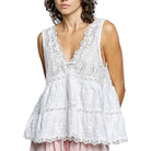 White lace dress worn by a model on a white background