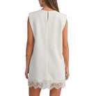 Cream dress with lace hem on a white background