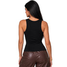 A woman shown from the back wearing a fitted black sleeveless tank top and brown faux-leather pants against a plain white studio background.