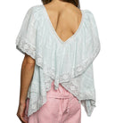 Light blue lace-trimmed top worn by a person on a white background