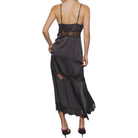 Woman wearing a black lace dress on a white background