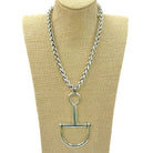 A silver horse bit chain necklace displayed on a beige fabric mannequin bust against a white background.