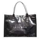 A glossy black patent leather tote bag with double top handles and 'TOTE BAG' printed in white across the front, shown on a plain white background.