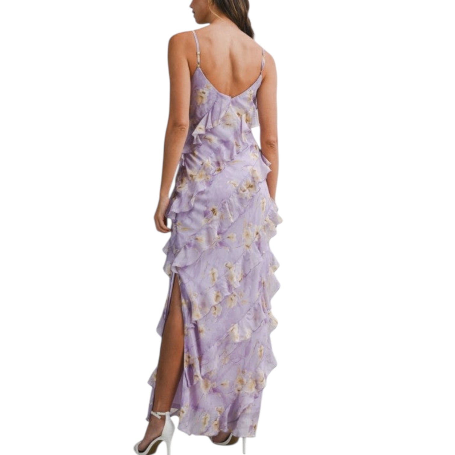 Woman wearing a purple floral dress with ruffles on a white background