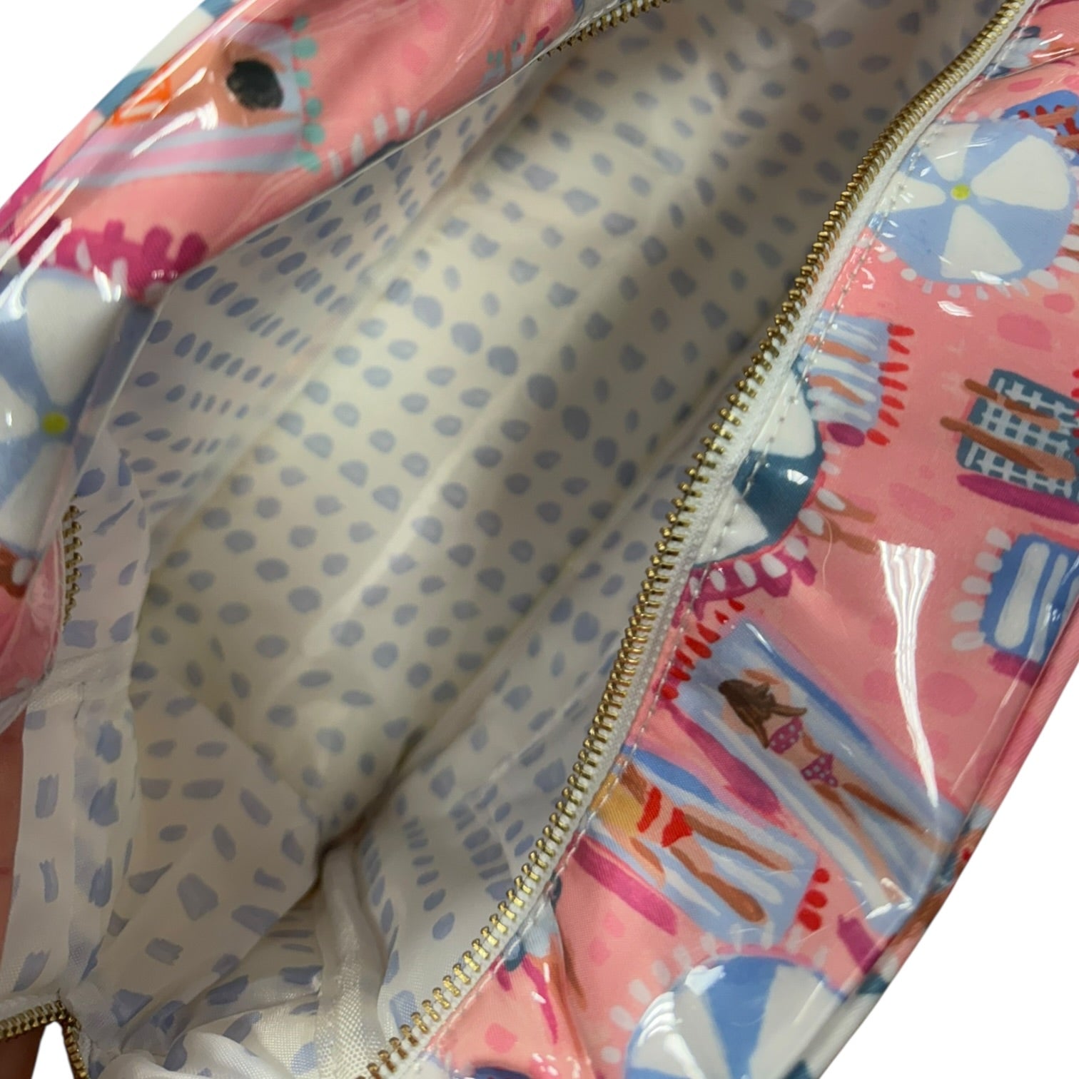 Colorful patterned pouch with a clear section showing a polka dot interior.