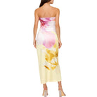 Woman wearing a strapless dress with floral design on a white background