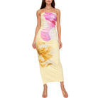 Woman wearing a strapless floral dress with pink and yellow flowers on a white background