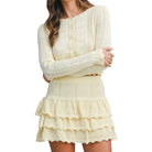 Woman wearing a lemon colored knitted set with a white background