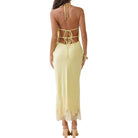 Yellow open-back dress with lace details on a white background