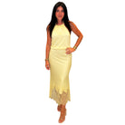 Woman wearing a yellow dress with lace details on a white background