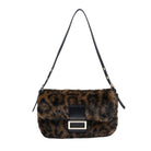 A leopard-print faux fur shoulder bag with a black leather strap and a gold-tone rectangular buckle on the front flap, shown against a plain white background.