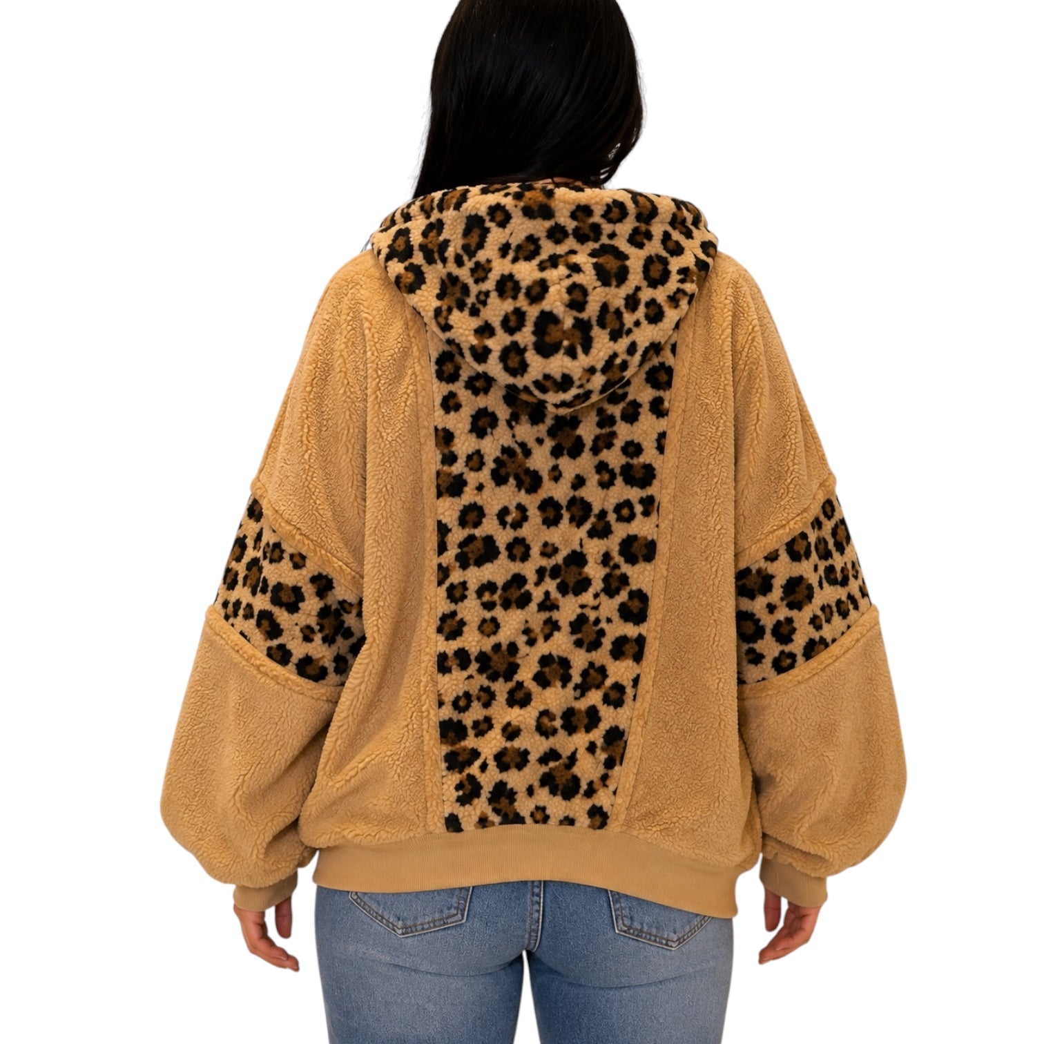 A person shown from the back wearing a tan sherpa hoodie with leopard-print panels on the hood, back, and sleeves, paired with blue jeans against a plain white background.