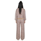 A model viewed from the back wearing a matching two-piece leopard print set in a dusty rose/taupe color with white side stripes on the sleeves and pants.