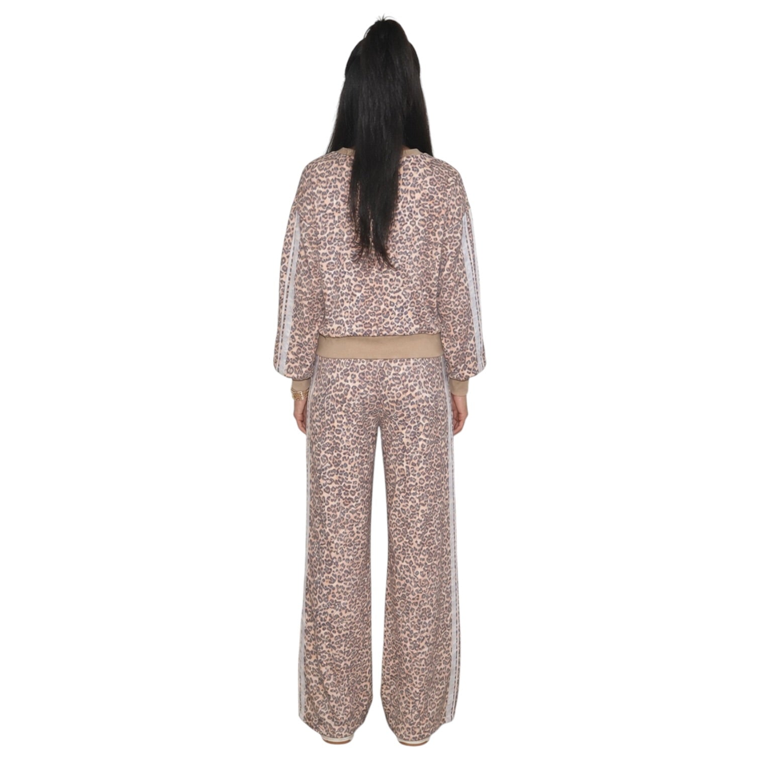 A model viewed from the back wearing a matching two-piece leopard print set in a dusty rose/taupe color with white side stripes on the sleeves and pants.