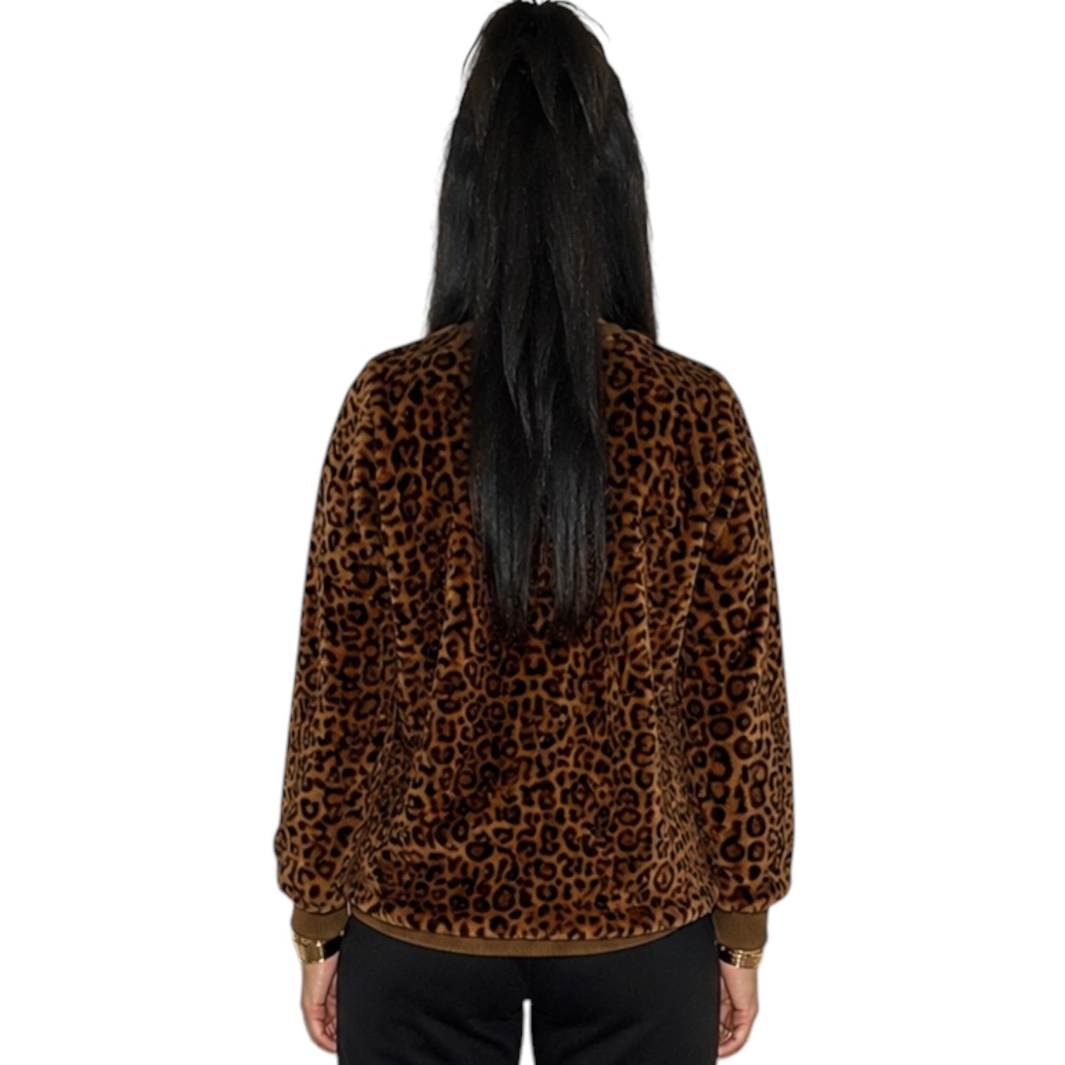 A person viewed from the back wearing a brown and black leopard print fleece jacket with black pants, set against a plain white background.