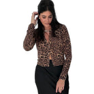Woman wearing a leopard print top on a white background