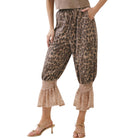 Leopard print pants with ruffled bottom hem worn by a person on a white background