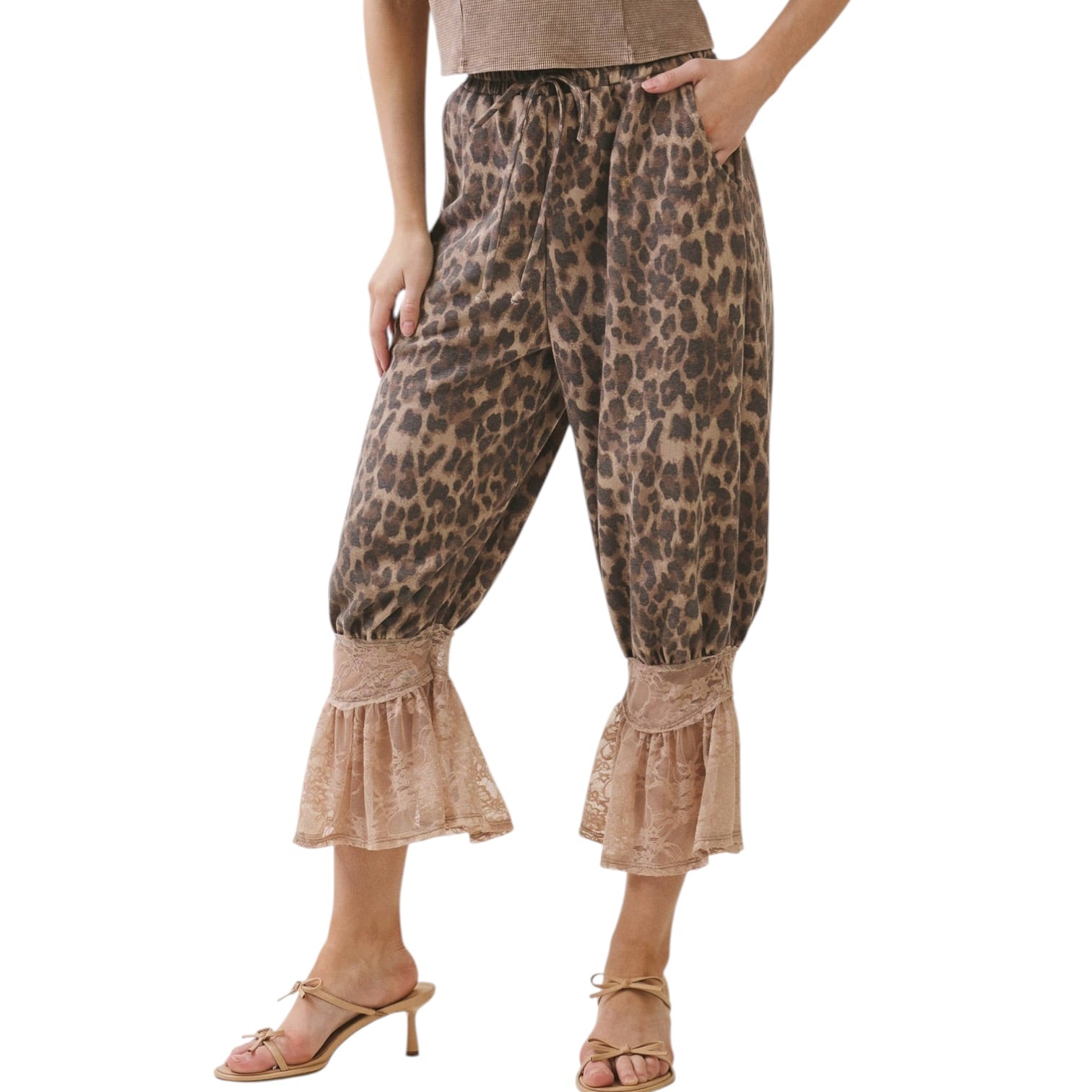 Leopard print pants with ruffled bottom hem worn by a person on a white background