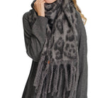 Leopard pattern fringe scarf, soft and stylish winter accessory.