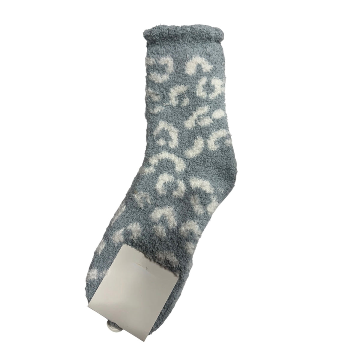 A single fuzzy slipper sock in a dusty blue-gray color with a white abstract pattern, shown on a plain white background with its paper tag attached.