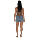 A woman shown from the back wearing a leopard-print strapless tube top and light-wash denim cutoff shorts, paired with black high heels, against a plain white background.