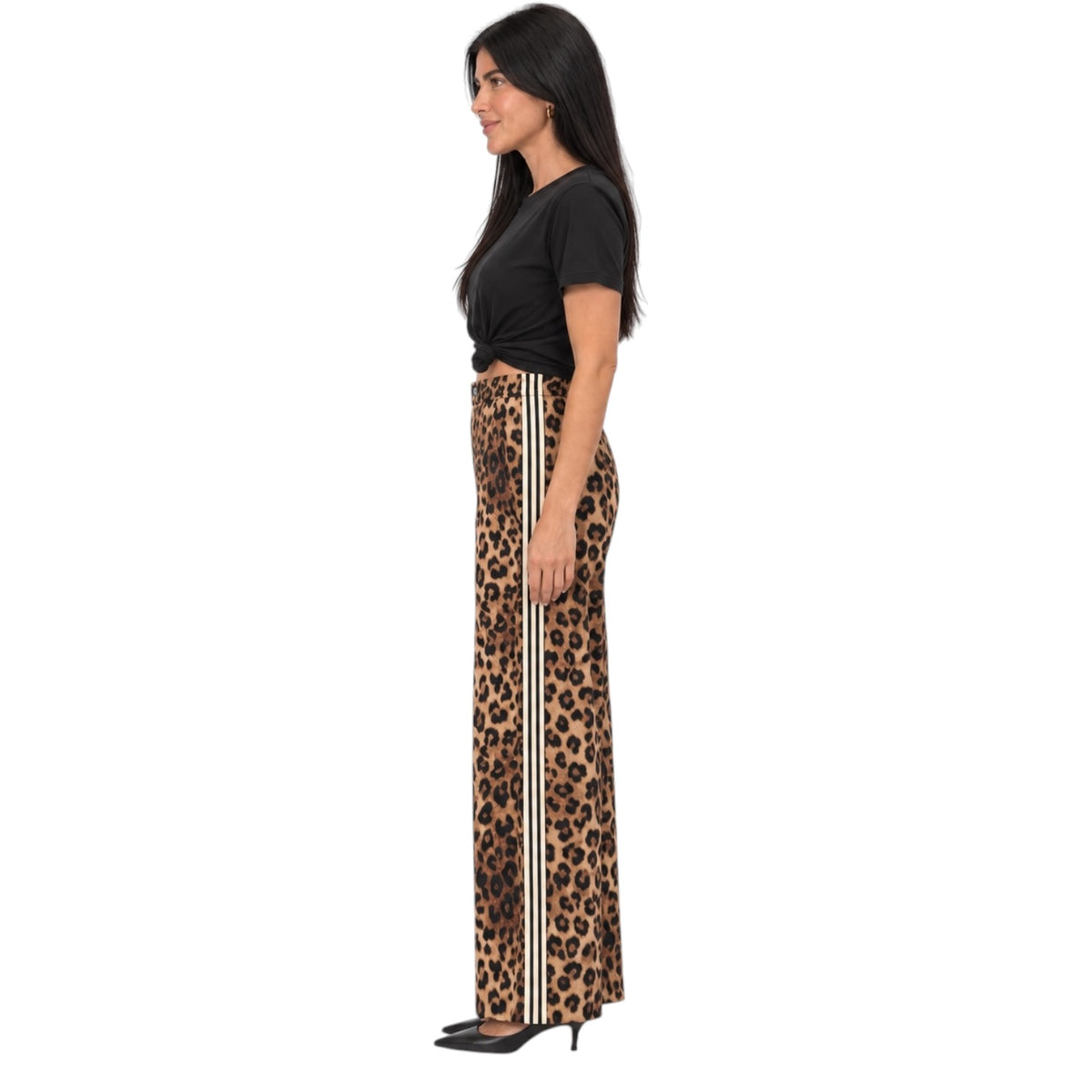 A woman shown in profile wearing leopard-print wide-leg pants with two vertical white stripes down the side, paired with a black cropped top and black heels, against a plain white background.