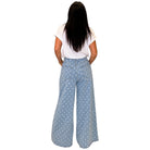 woman wearing light denim polka dot wide leg pants on white background
