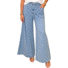 woman wearing light denim polka dot wide leg pants on white background